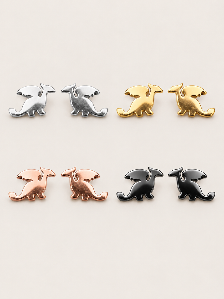 Stainless Steel Dragon Stud Earrings in silver, gold, rose gold and black on a warm neutral background