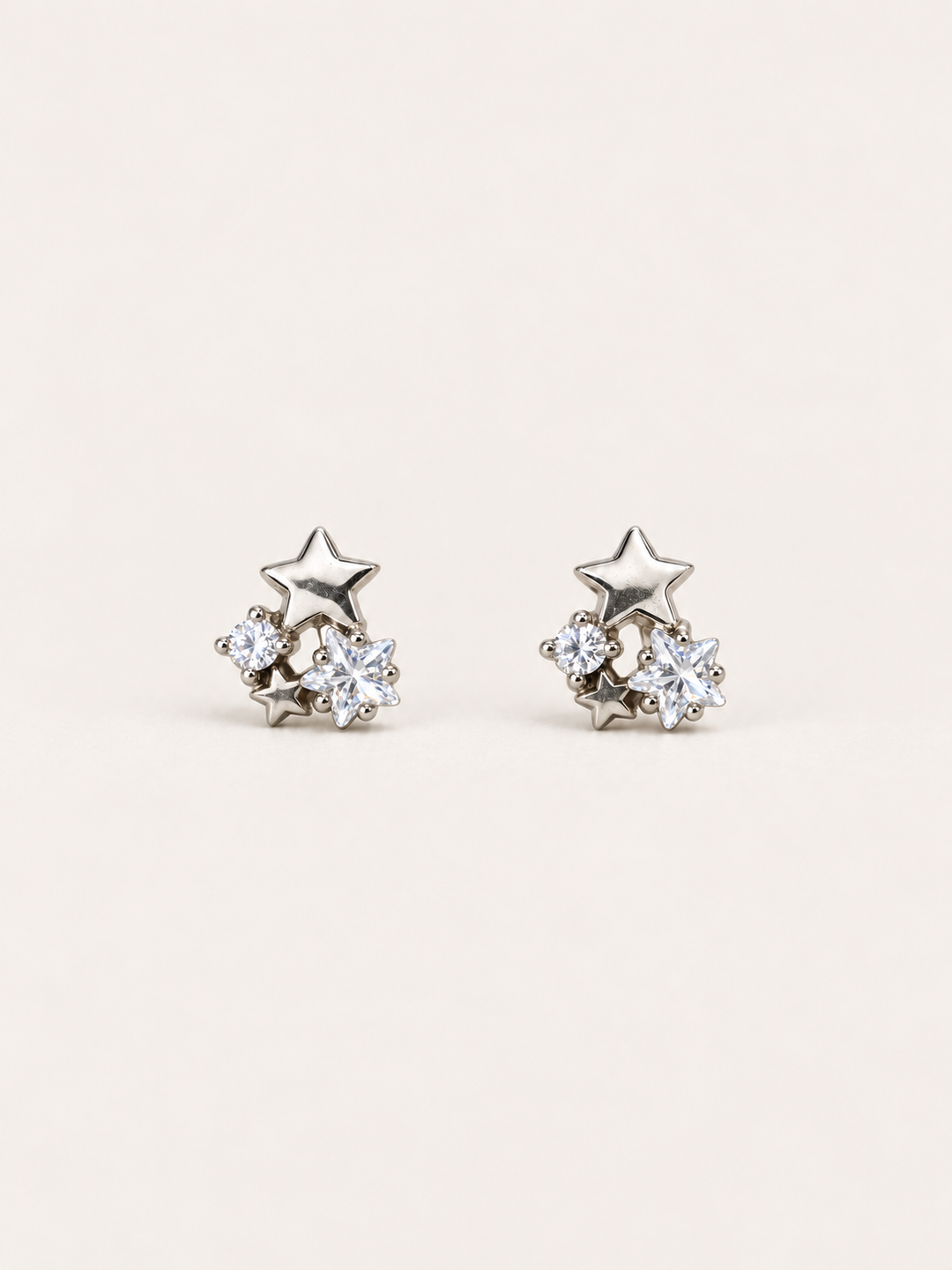 Star and Crystal Cluster Stud Earrings shown on a warm neutral background