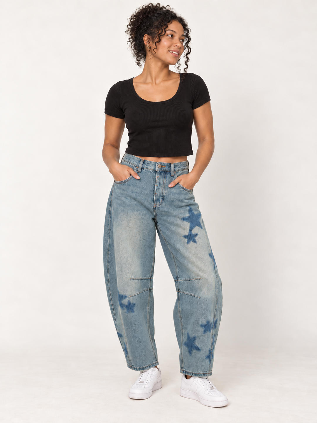 Model wearing Star Printed Washed Denim Barrel Jeans, front view