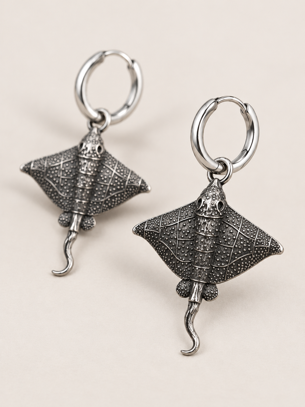 Stingray Hoop Earrings shown angled on a warm neutral background