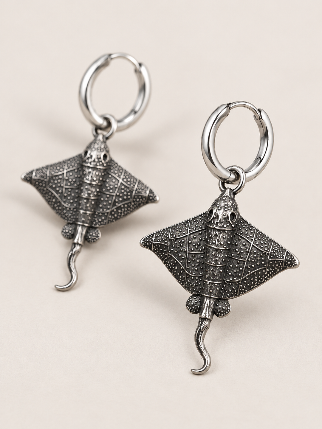 Stingray Hoop Earrings shown angled on a warm neutral background