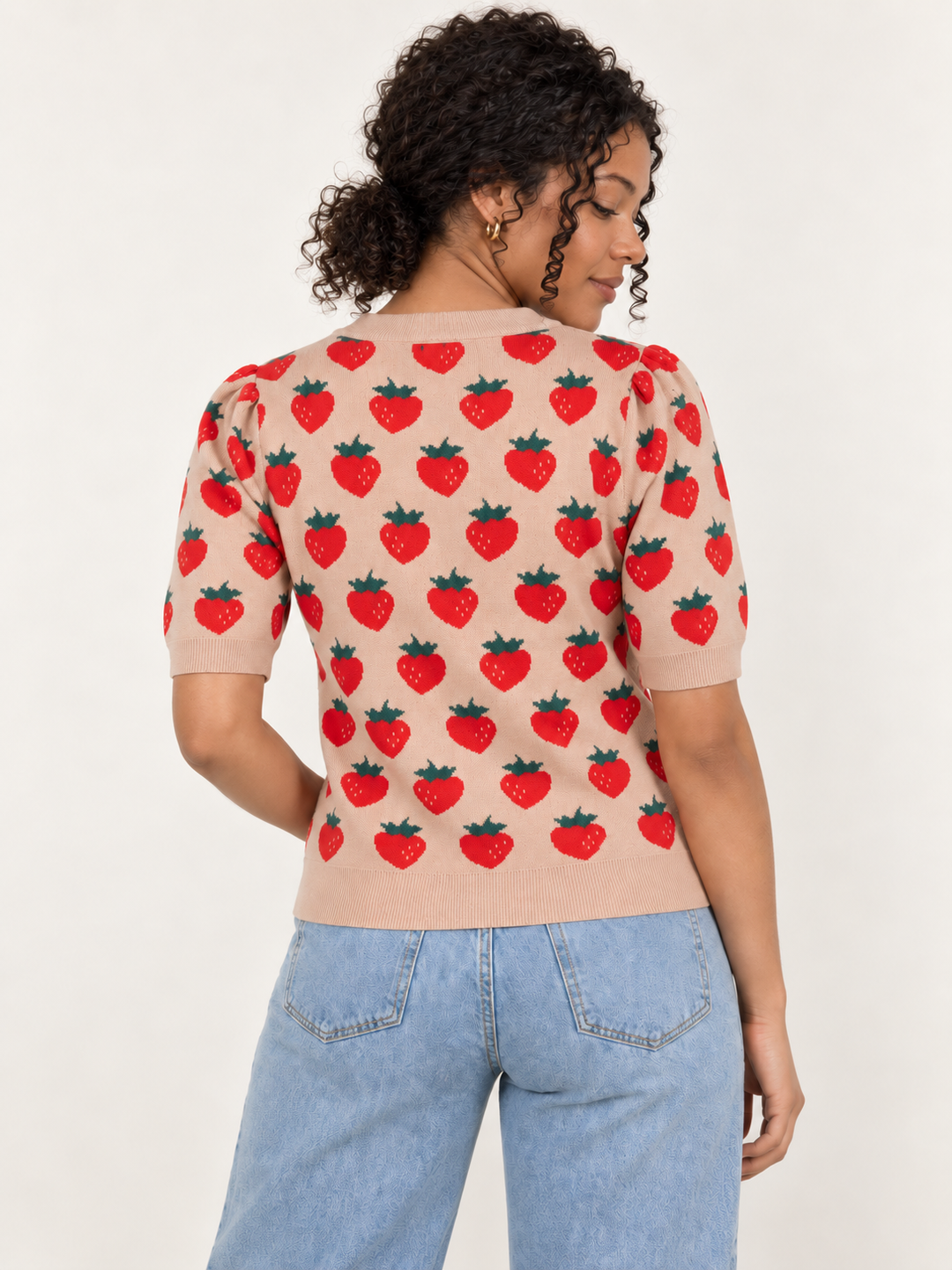 Model wearing strawberry knit short sleeve top in camel, back view