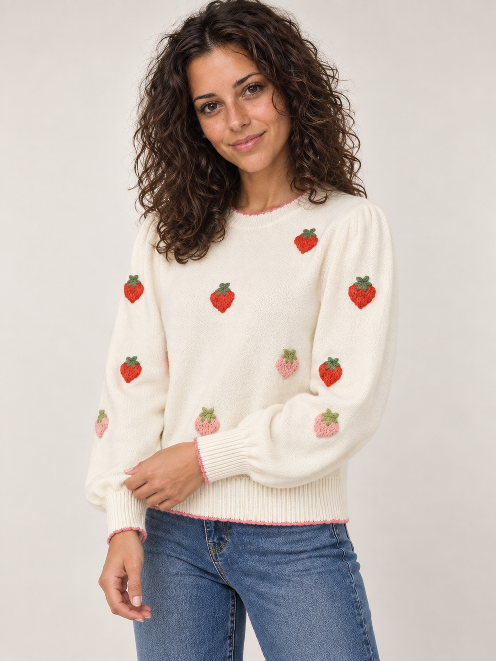 Three-quarter view of model wearing Strawberry Red to Pink Embroidery Sweater