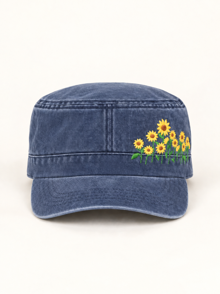 Front view of washed blue sunflower cadet hat on a warm cream background