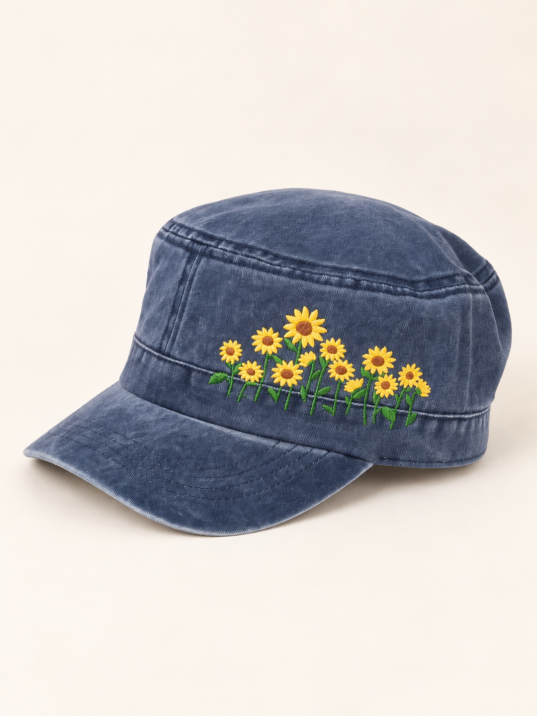 Three-quarter view of washed blue cadet hat with yellow sunflower embroidery