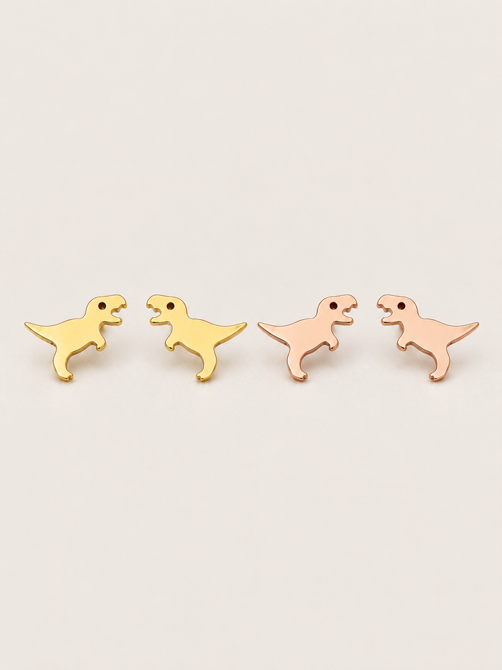 T. Rex Stud Earrings in gold and rose gold shown on a warm neutral background