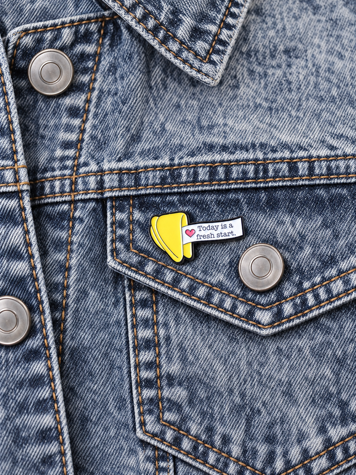 Today Is a Fresh Start Fortune Cookie Pin displayed on acid-wash denim beside a metal button