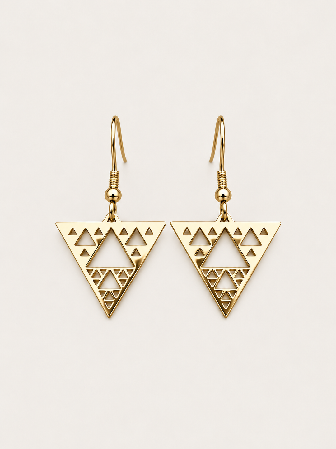 Gold Triangle Cutout Drop Earrings shown on a warm neutral background