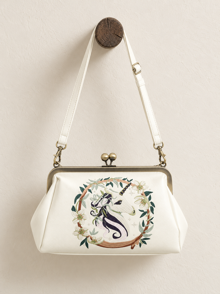 Unicorn Kisslock Bag hanging from wooden display post