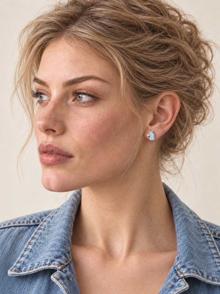 Silver Unicorn Stud Earrings worn on a model with a light blue denim jacket
