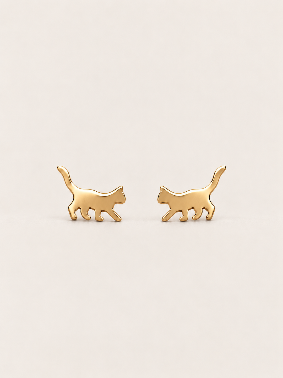 Gold Walking Cat Stud Earrings shown on a warm neutral background
