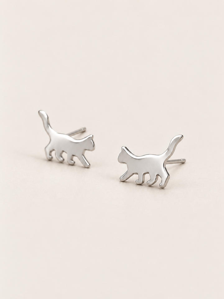 Silver Walking Cat Stud Earrings shown angled on a warm neutral background