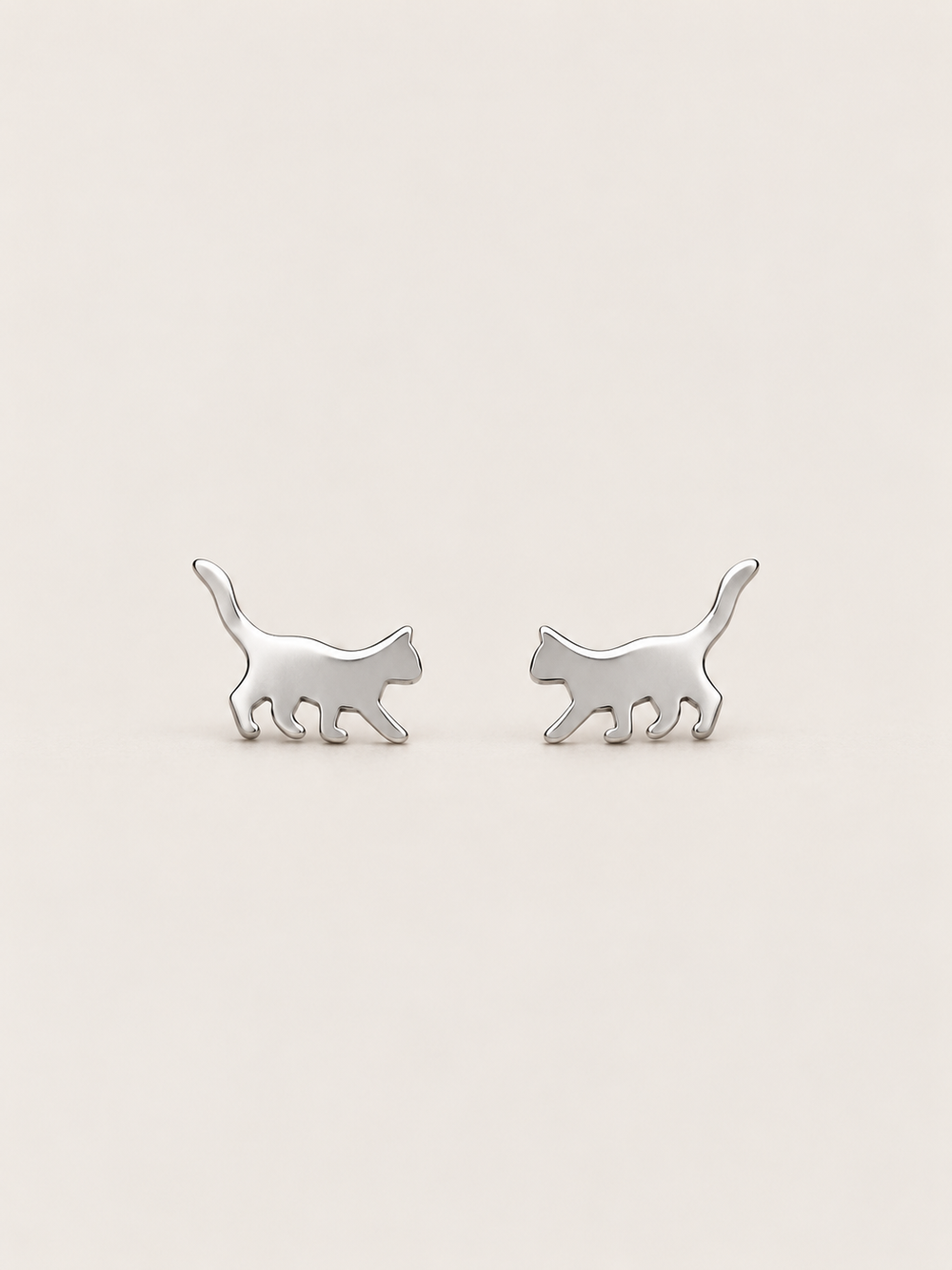 Silver Walking Cat Stud Earrings shown on a warm neutral background