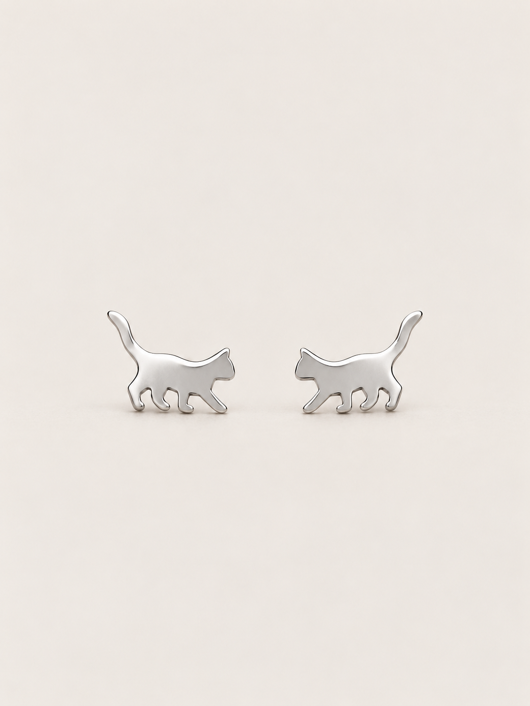 Silver Walking Cat Stud Earrings shown on a warm neutral background