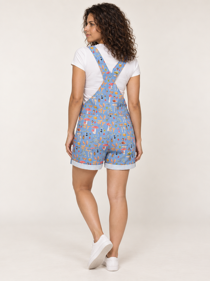 Model wearing Woodland Mushroom Short Overalls Blue, full-body back view