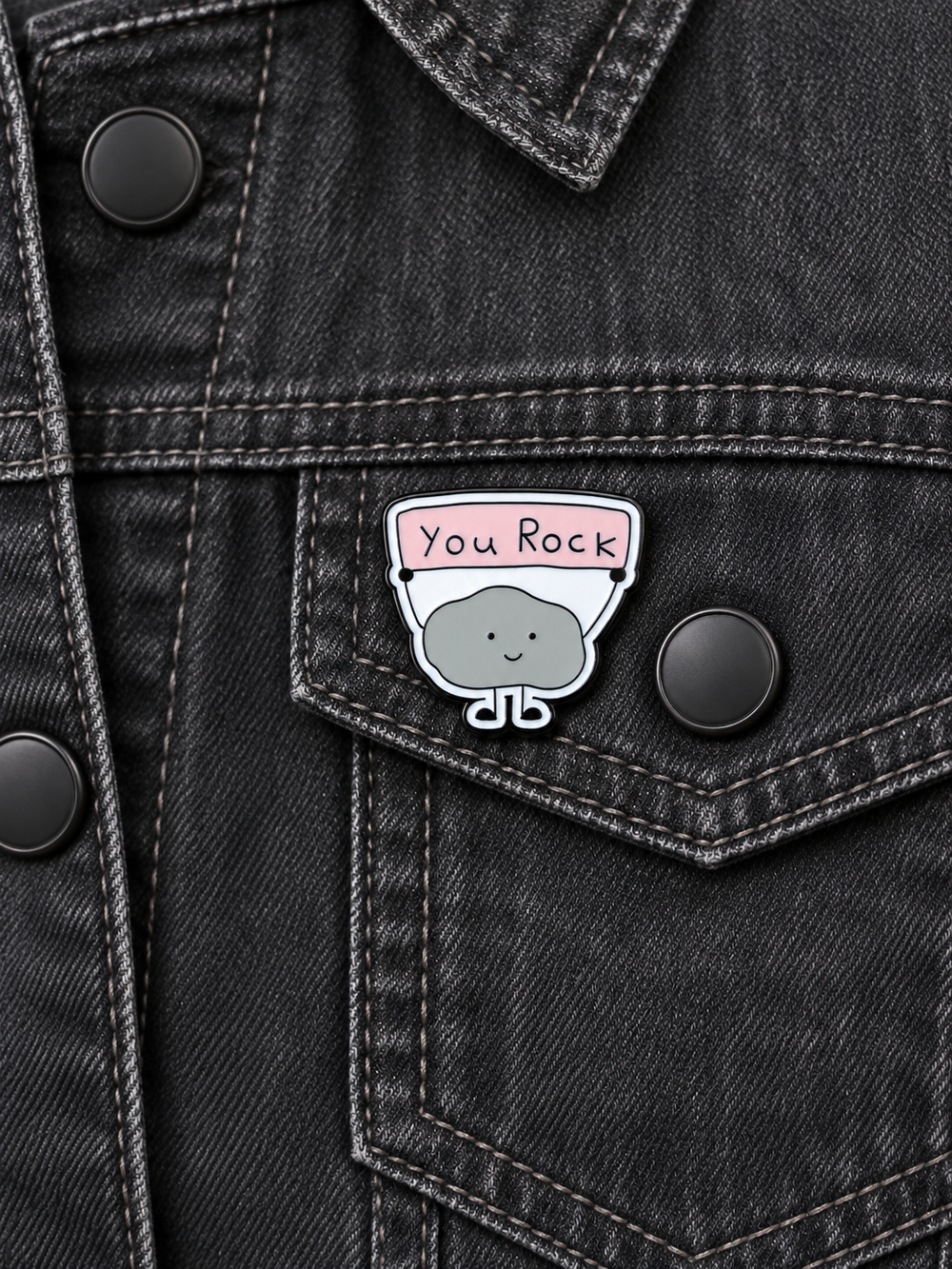 You Rock Cute Rock Pin displayed on a charcoal denim jacket beside a metal button